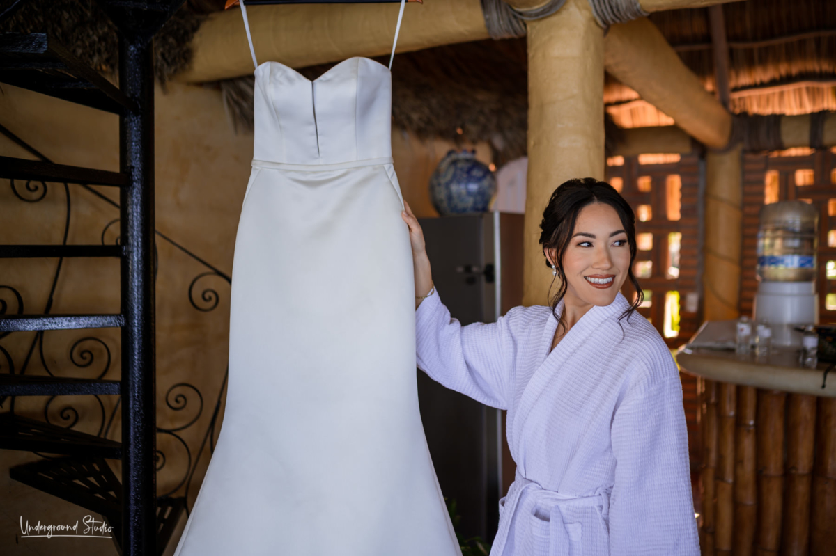 wedding dress hanging with bride