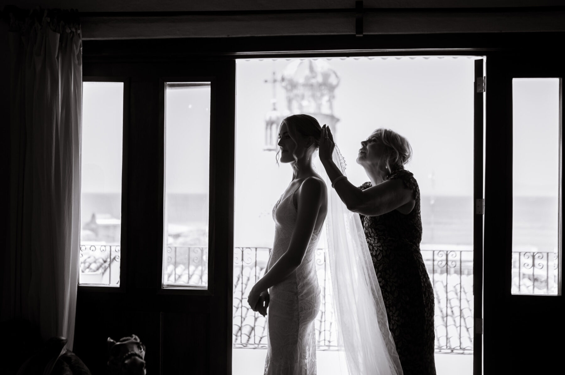 mom putting veil on bride